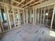 Unfinished living room features wood framework, flooring, and window placement for future customization at 2932 Fairfield S Ave, St Petersburg, FL 33712