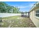 Backyard with a white fence and a view of the house with screened porch at 3021 Jarvis St, Holiday, FL 34690
