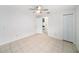 Well-lit bedroom with tiled floors, closet, and a ceiling fan for added comfort at 3021 Jarvis St, Holiday, FL 34690
