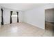 Cozy bedroom with tiled floors, window, neutral walls, and a door to an ensuite bathroom at 3021 Jarvis St, Holiday, FL 34690