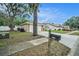 Street view of the property with a two-car garage, mature trees, and a mailbox at 3021 Jarvis St, Holiday, FL 34690