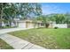 Charming single-story home with a two-car garage, stone accents, and well-maintained lawn at 3021 Jarvis St, Holiday, FL 34690