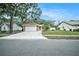 Charming single-story home with a two-car garage, stone accents, and a well-maintained lawn at 3021 Jarvis St, Holiday, FL 34690
