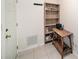 Hallway with white door, shelving unit and wooden table at 3021 Jarvis St, Holiday, FL 34690