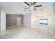 Spacious living room with tile flooring, a modern ceiling fan, and sliding glass doors to the patio at 3021 Jarvis St, Holiday, FL 34690