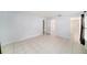 Bright main bedroom with tile flooring, multiple doorways, and neutral paint at 3021 Jarvis St, Holiday, FL 34690