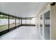 An empty screened porch with concrete floor and a view of the backyard at 3021 Jarvis St, Holiday, FL 34690