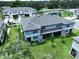 An aerial view of a lovely home near a pond with a lush green lawn at 30729 Veridian Way, Wesley Chapel, FL 33543