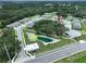 Aerial view of the Townes at Veridian community featuring lush landscaping, pond and attractive townhomes at 30729 Veridian Way, Wesley Chapel, FL 33543