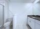 Modern bathroom with tiled floors, granite countertop, and a glass shower enclosure at 30729 Veridian Way, Wesley Chapel, FL 33543