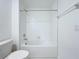 A full bathroom with a white tile shower-tub combo and a low-flow toilet at 30729 Veridian Way, Wesley Chapel, FL 33543