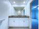This bathroom features double granite sinks and a view of the shower-tub combo at 30729 Veridian Way, Wesley Chapel, FL 33543