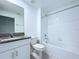 Bathroom boasts granite countertop vanity and a shower-tub combo with white tile at 30729 Veridian Way, Wesley Chapel, FL 33543