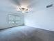 Bright bedroom with a view of trees, carpet, and a ceiling fan at 30729 Veridian Way, Wesley Chapel, FL 33543