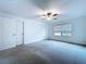 Bedroom with a ceiling fan, closet, and a large window for natural light at 30729 Veridian Way, Wesley Chapel, FL 33543