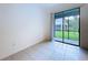 Bright room with tile floors and sliding glass door to patio at 30729 Veridian Way, Wesley Chapel, FL 33543