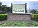 Attractive community sign for Townes at Veridian with brick base and manicured landscaping at 30729 Veridian Way, Wesley Chapel, FL 33543