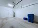This is a well-lit garage, ready for storage, with the water heater on view at 30729 Veridian Way, Wesley Chapel, FL 33543