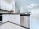 This kitchen features stainless steel appliances, white cabinets, and granite countertops at 30729 Veridian Way, Wesley Chapel, FL 33543