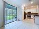Modern kitchen with stainless steel appliances and sliding glass doors to the screened lanai at 30729 Veridian Way, Wesley Chapel, FL 33543