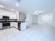 Modern kitchen features stainless steel appliances, white cabinetry, and granite countertops at 30729 Veridian Way, Wesley Chapel, FL 33543