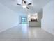 Spacious living room boasts tile floors, ceiling fan, and sliding glass doors at 30729 Veridian Way, Wesley Chapel, FL 33543
