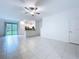 Bright living room features neutral tones, tile flooring, and seamless kitchen access at 30729 Veridian Way, Wesley Chapel, FL 33543