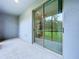Covered patio with sliding glass door and view of the backyard at 30729 Veridian Way, Wesley Chapel, FL 33543