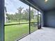 Screened-in patio with a view of the lush green yard and mature trees at 30729 Veridian Way, Wesley Chapel, FL 33543