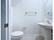 Powder room featuring tile flooring, toilet, and pedestal sink at 30729 Veridian Way, Wesley Chapel, FL 33543