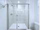 Shower with glass doors and tiled walls at 30729 Veridian Way, Wesley Chapel, FL 33543