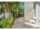 Beautiful backyard patio area with lush greenery, palm trees, and a serene outdoor space for relaxation and entertaining at 3144 W Waverly Park, Tampa, FL 33629