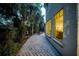 Inviting backyard with brick patio and a garden leading to an outdoor dining area at 3144 W Waverly Park, Tampa, FL 33629