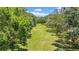 A lush green backyard featuring mature trees and meticulously maintained lawn at 3144 W Waverly Park, Tampa, FL 33629