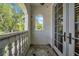 Cozy balcony with textured walls and a charming arched window overlooking lush greenery at 3144 W Waverly Park, Tampa, FL 33629