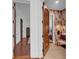 The Primary bath features an open doorway, decorative wallpaper, a unique furniture style vanity, and tile floors at 3144 W Waverly Park, Tampa, FL 33629