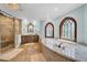 Bright bathroom with soaking tub, walk-in shower, and marble countertops at 3144 W Waverly Park, Tampa, FL 33629