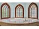 Bathroom featuring a soaking tub with marble surround and ornate windows at 3144 W Waverly Park, Tampa, FL 33629