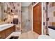 Modern bathroom with a walk-in shower, stylish fixtures, and unique wall coverings at 3144 W Waverly Park, Tampa, FL 33629