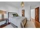 Bedroom features a decorative pendant light, hardwood floors, and a view to the Primary bath through an open doorway at 3144 W Waverly Park, Tampa, FL 33629