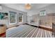 Bright Bedroom featuring a crib, hardwood floors with a striped rug, and hand-painted wall decorations at 3144 W Waverly Park, Tampa, FL 33629