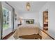 Bright bedroom featuring a bed with neutral bedding, a pendant light, and an ensuite bathroom view at 3144 W Waverly Park, Tampa, FL 33629