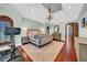 Spacious bedroom featuring hardwood floors, tray ceilings, and a seating area with natural light at 3144 W Waverly Park, Tampa, FL 33629