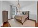 This bedroom features a lovely pendant light, neutral walls, hardwood floors, and is illuminated by a large window at 3144 W Waverly Park, Tampa, FL 33629