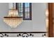 Beautiful crystal chandelier hanging above wrought iron railing near large window at 3144 W Waverly Park, Tampa, FL 33629