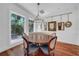 A well-lit dining area featuring a round table, custom seating, and natural light through large windows at 3144 W Waverly Park, Tampa, FL 33629