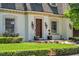 Charming home featuring a decorative wood front door, manicured lawn, and detailed architectural trim at 3144 W Waverly Park, Tampa, FL 33629