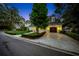 Elegant home featuring a well-manicured lawn, lush landscaping, and a charming garage at 3144 W Waverly Park, Tampa, FL 33629