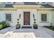 Charming home featuring a decorative wood front door, manicured lawn, and detailed architectural trim at 3144 W Waverly Park, Tampa, FL 33629