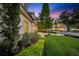 Beautiful front lawn with lush landscaping, colorful flowerbeds, and mature trees adding to the curb appeal at 3144 W Waverly Park, Tampa, FL 33629